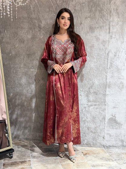 Woman in a Burgundy Metallic Luxury Kaftan dress standing on a marble floor