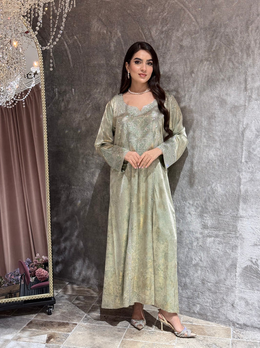 Woman in a Mint Green Metallic Luxury Kaftan dress standing in front of a mirror on a gray floor.