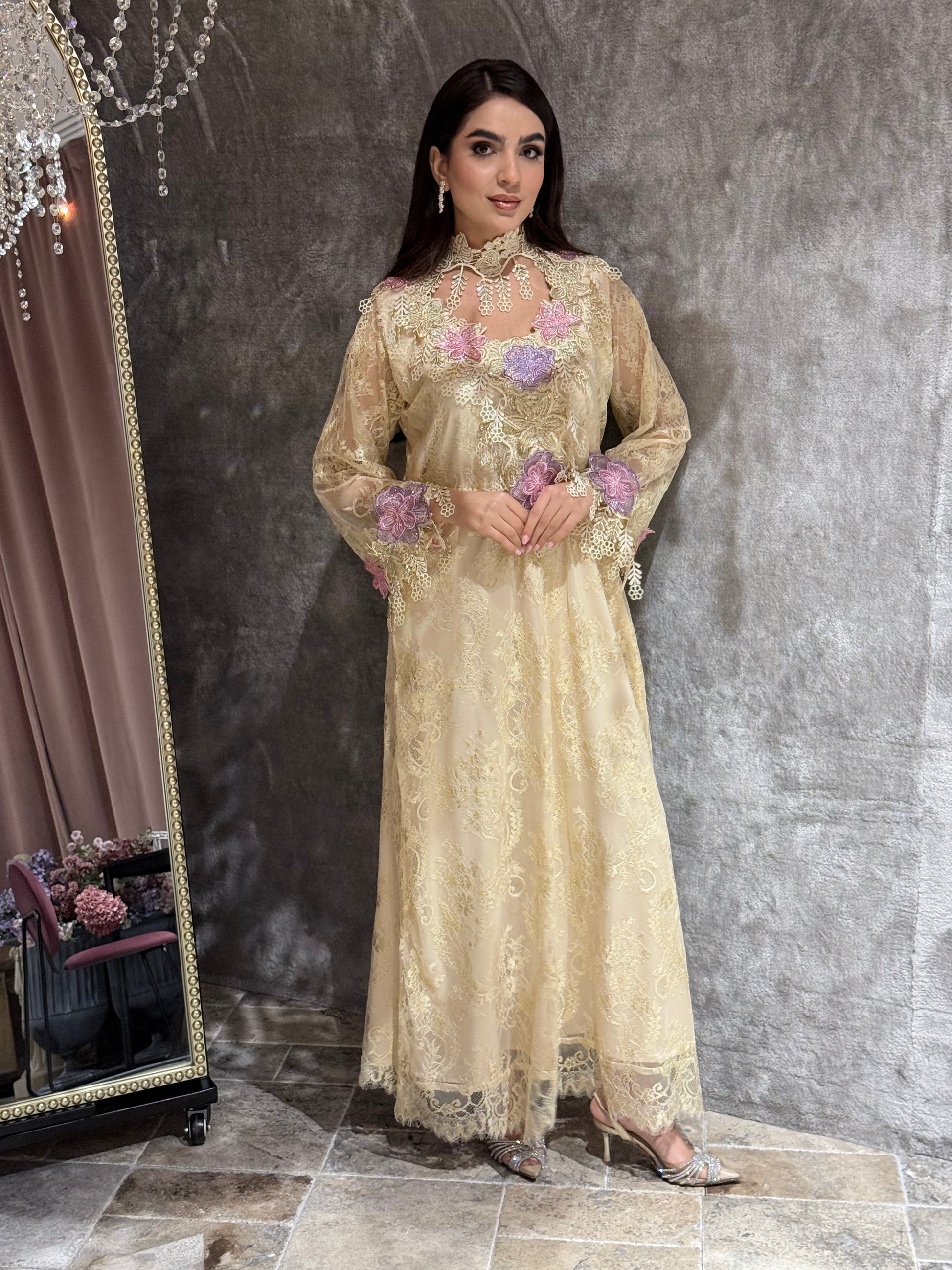 Woman in a long, elegant Cream Floral Lace Luxury Kaftan dress standing in front of a mirror.