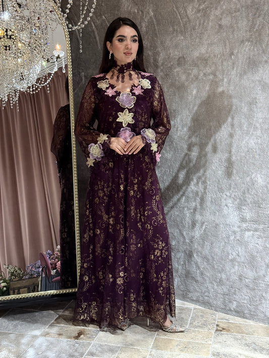 Woman in a dark purple floral kaftan dress standing in front of a mirror.