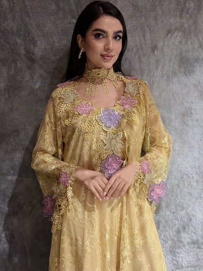 Woman wearing a Golden Saffron Floral Lace Luxury Kaftan embroidered dress with floral patterns on a gray background