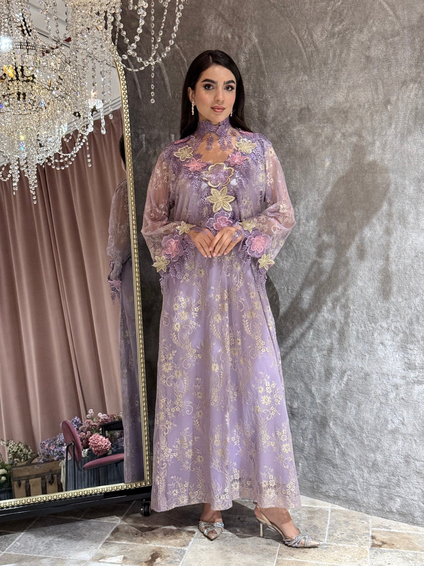 Woman in a Lavender Mist Floral Lace Luxury Kaftan floral dress standing in front of a mirror.