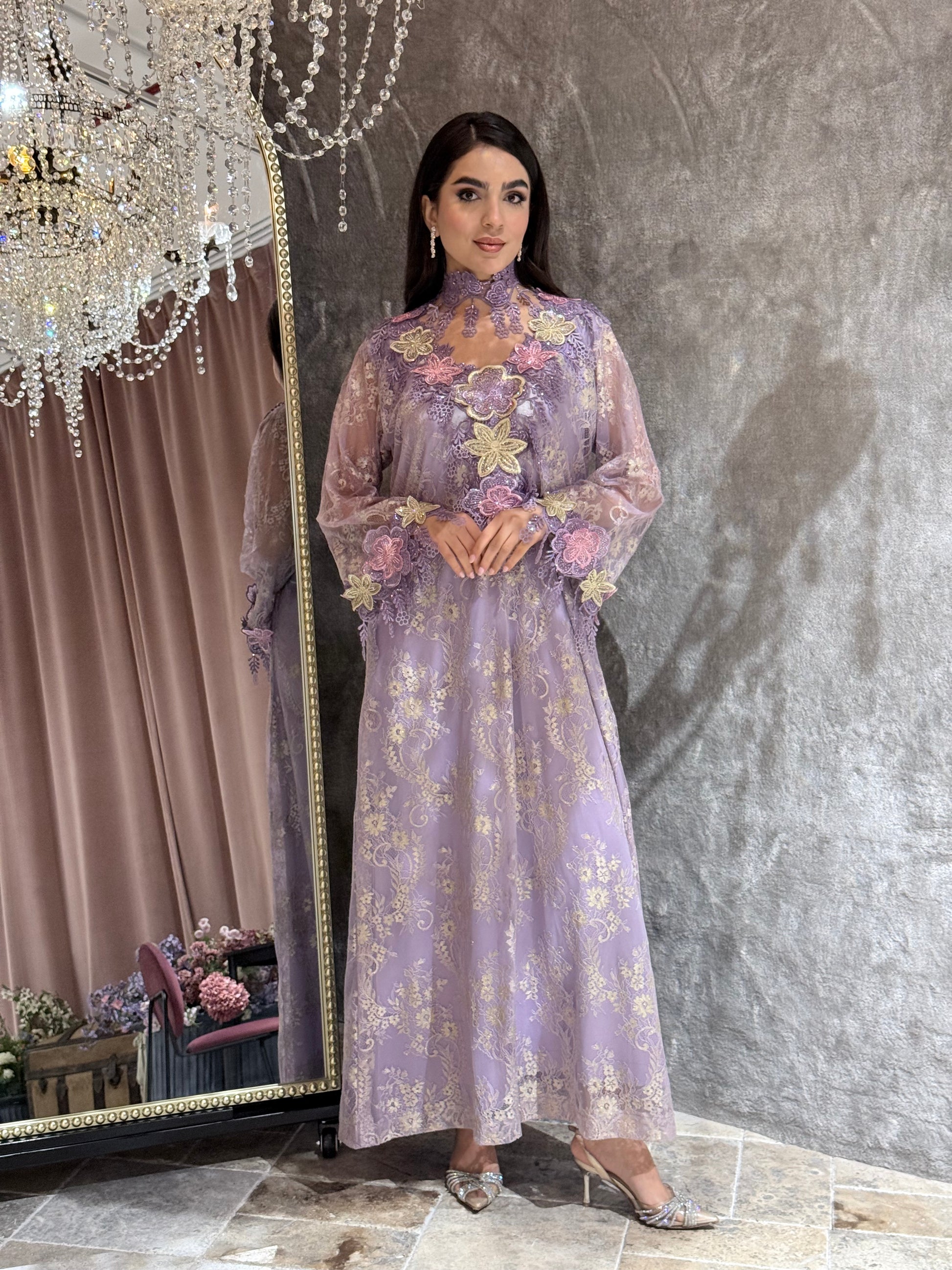 Woman in a Lavender Mist Floral Lace Luxury Kaftan floral dress standing in front of a mirror.