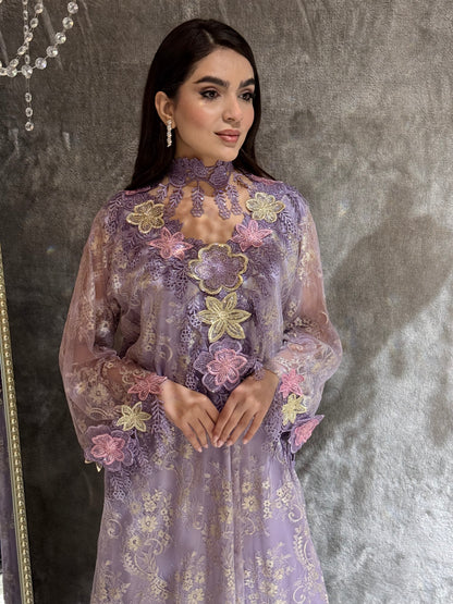 Woman in a Lavender Mist Floral Lace Luxury Kaftan floral dress standing on a textured floor.
