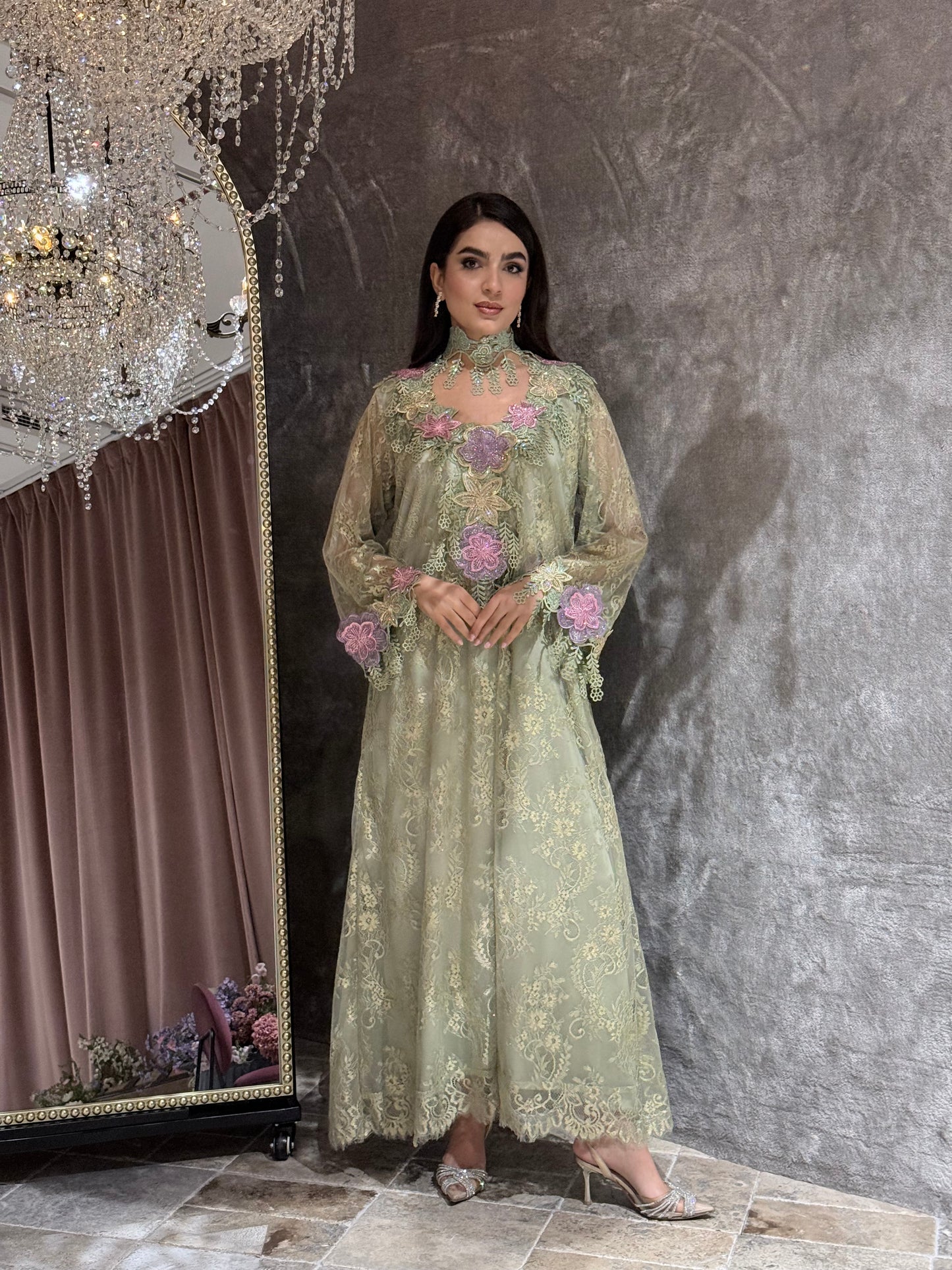 Woman in a Mint Green Floral Lace Luxury Kaftan dress standing in front of a mirror.