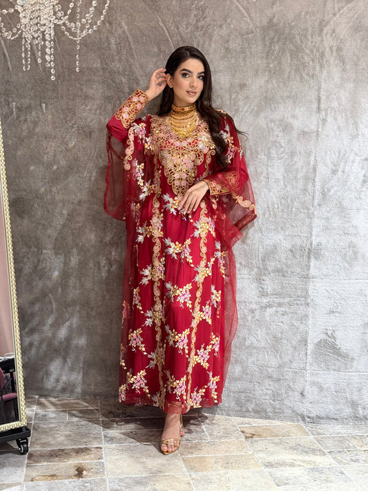 Woman in a Maroon Luxury Embroidered Kaftan traditional outfit standing on a marble floor.