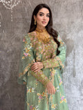 Woman in a Mint Green Luxury Kaftan dress standing against a textured wall.
