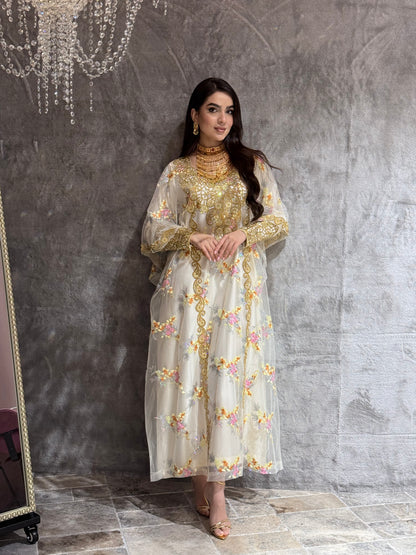 Woman in a Off-White Luxury Floral Kaftan dress standing on a marble floor.
