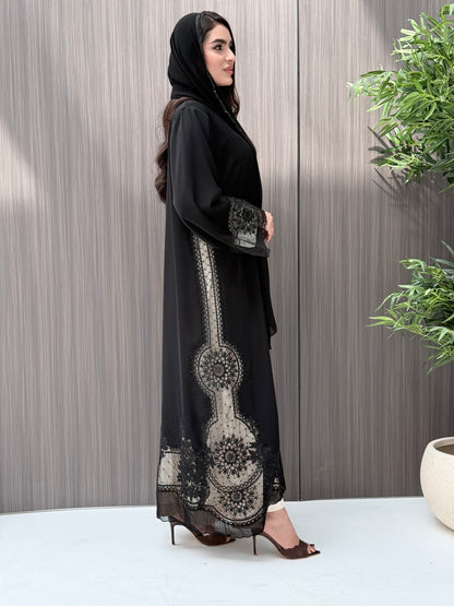 Woman wearing a luxury open-front black abaya crafted from premium Nida fabric with matching sheila standing indoor