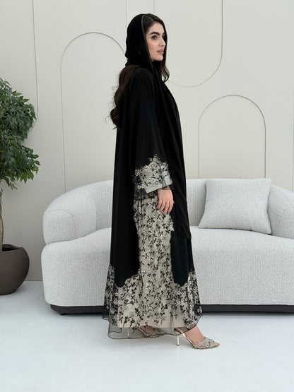 Woman wearing an elegant luxury open-front black abaya crafted from premium Nida fabric with a matching sheila.
 on a white background