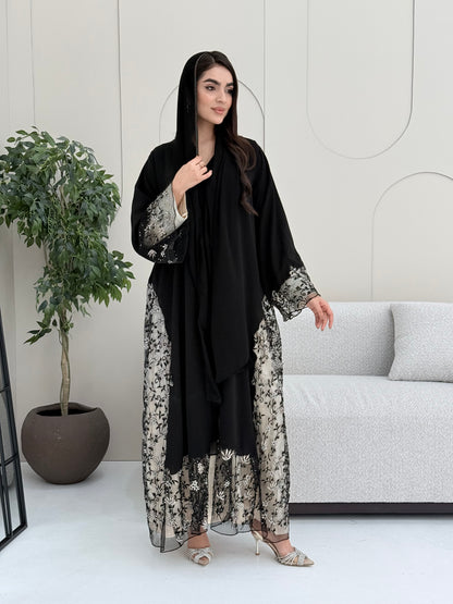 Woman wearing an elegant luxury open-front black abaya crafted from premium Nida fabric with a matching sheila.
 on a white background