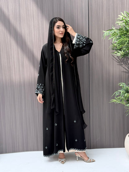 A woman wearing a black embroidered floral open abaya, which is perfect for ceremonies, Eid, and parties.