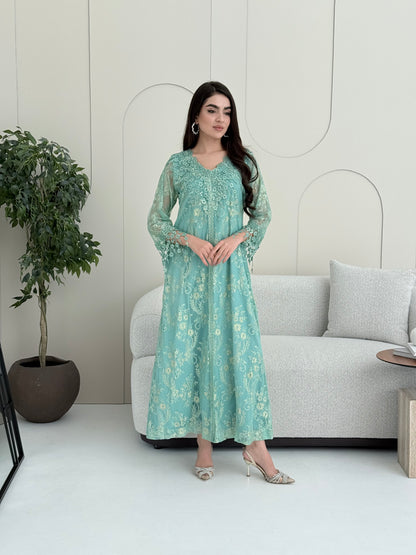 A woman wearing aqua blue floral lace kaftan, perfect for Eid, luxury occasions and parties.