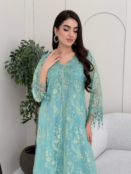 A woman wearing aqua blue floral lace kaftan, perfect for Eid, luxury occasions and parties.