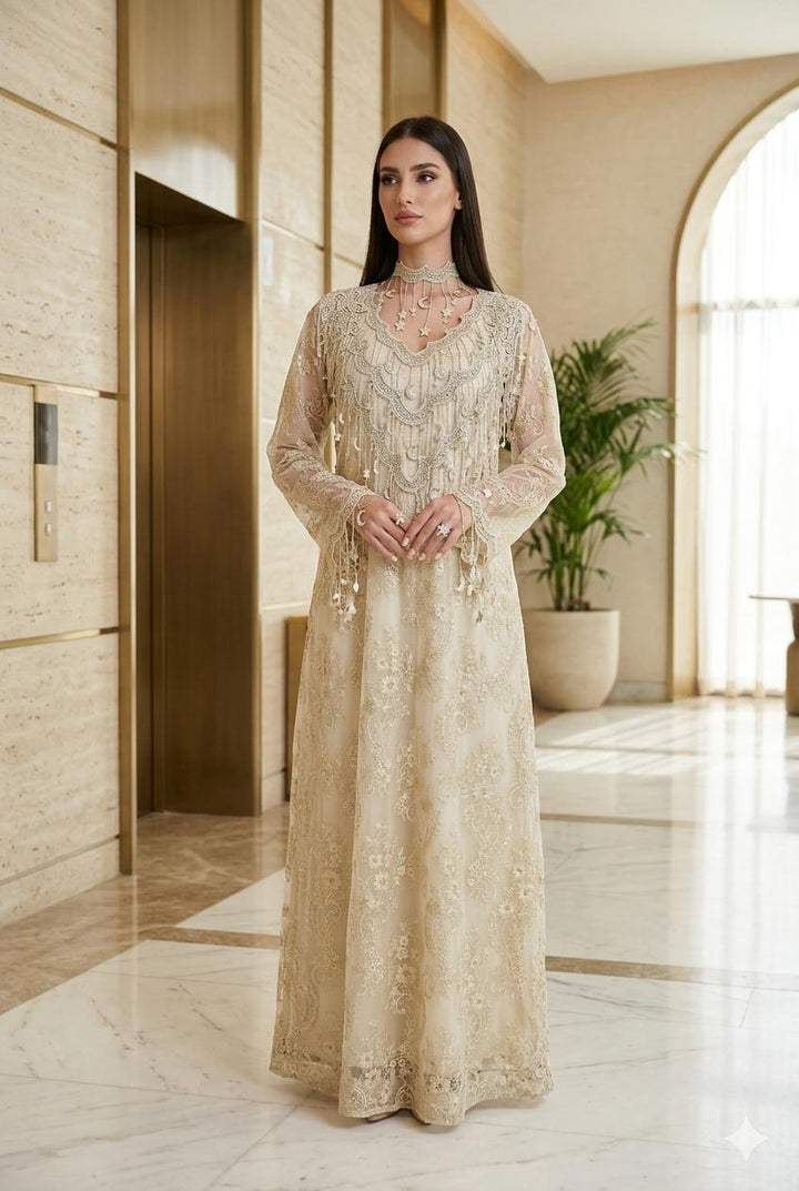 Woman in a long, Cream Floral High-Neck Lace Kaftan Perfect for Eid, Ramadan, Weddings, Henna, and Parties standing in an elegant interior setting.