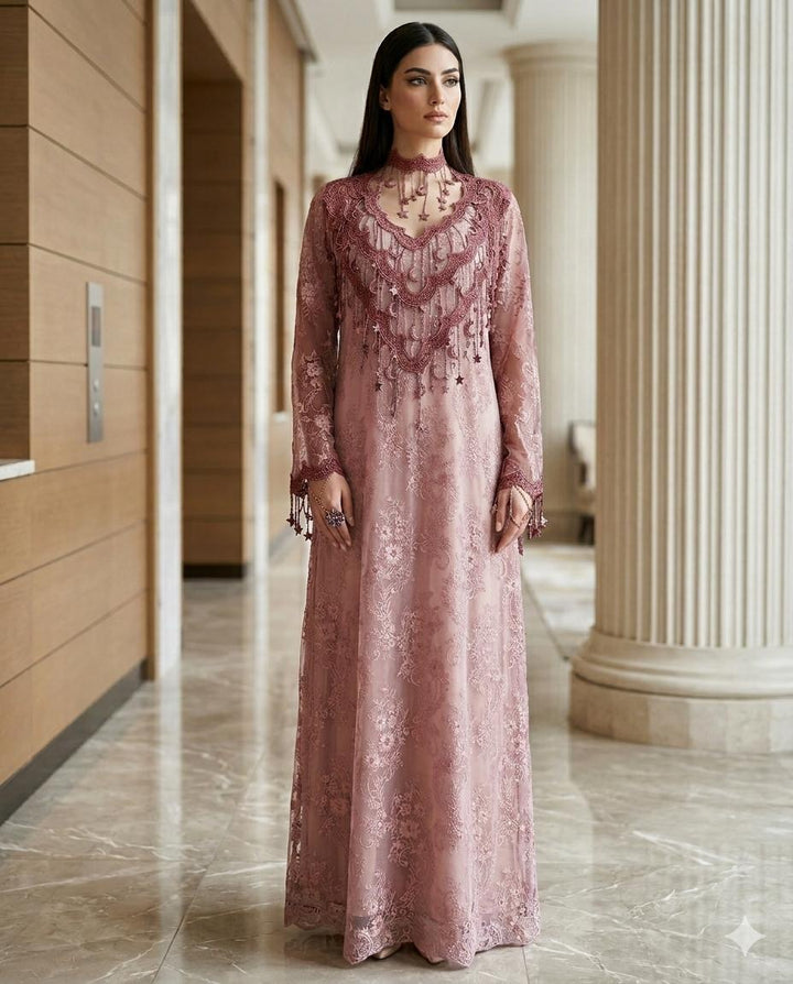 Woman in a long, Dusty Pink Floral High-Neck Lace Kaftan Perfect for Eid, Ramadan, Weddings, Henna, and Parties standing in an elegant interior setting.