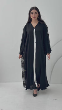 A black nida premium fabric abaya, that has floral lace (dantel) panel run vertically down the sides and sleeves.Perfect for Eid and special events.