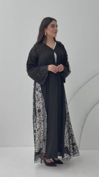 A premium black nida abaya, this abaya features floral lace(dantel) panels on the sides and sleeves. Perfect for daytime occasions and formal events.