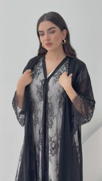 A black abaya of chiffon material with lace overlay, This abaya is perfect for Eid, dinner outings, and parties.