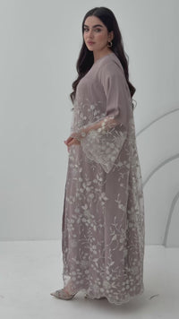 A luxurious and romantic mauve pink abaya with floral lace and Nida fabric, that is perfect for engagements, henna parties and weddings.