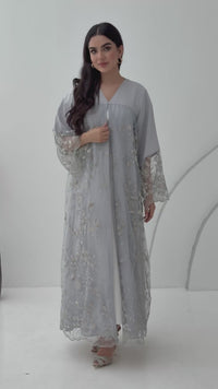A luxurious and romantic light grey abaya with floral lace and Nida fabric, that is perfect for engagements, henna parties and weddings.